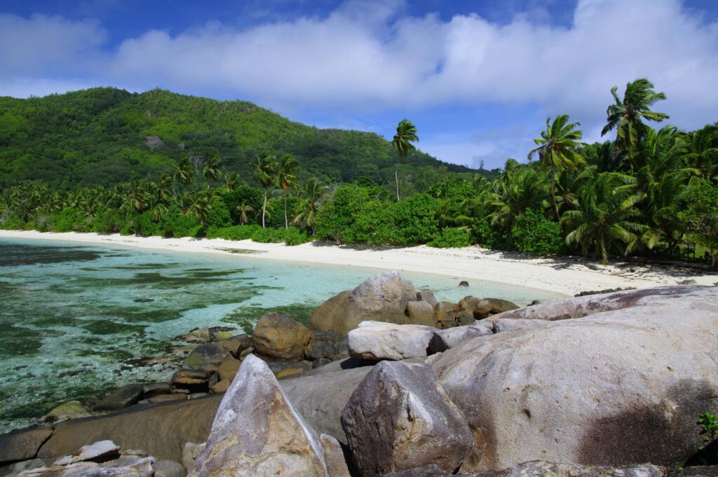verdant Seychelles mountains near tropical beach